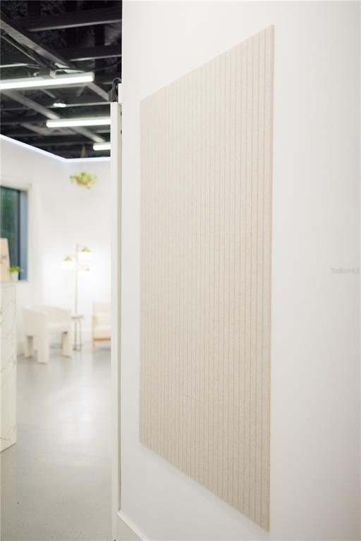 A vertical, light-colored, ribbed wall panel is mounted on a white wall in a room — 120 E MARKS STREET UNIT 200, ORLANDO, FL