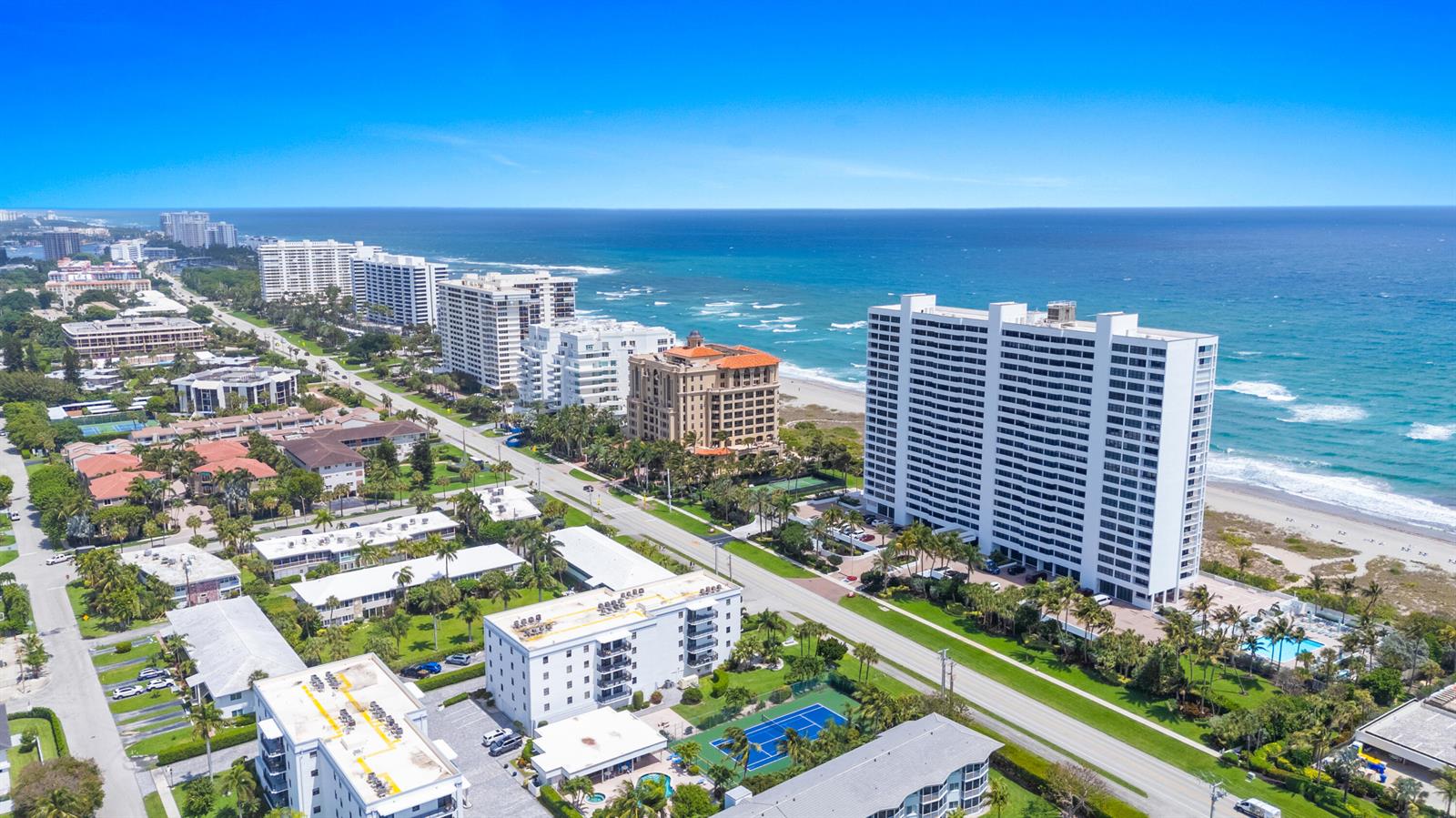 An aerial view shows high-rise apartment buildings along a sandy beach and oceanfront — 2600 S Ocean Boulevard, Boca Raton FL 33432, BOCA RATON, FL