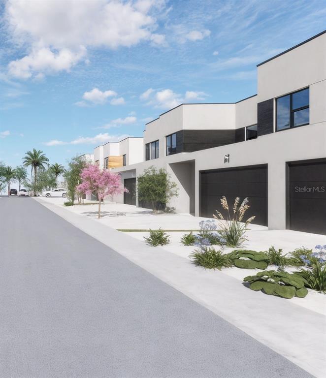 This is a rendering of modern townhomes with black garage doors and minimalist white facades — 5750 CYRILS ROAD TH FL LOT 17, ST CLOUD, FL