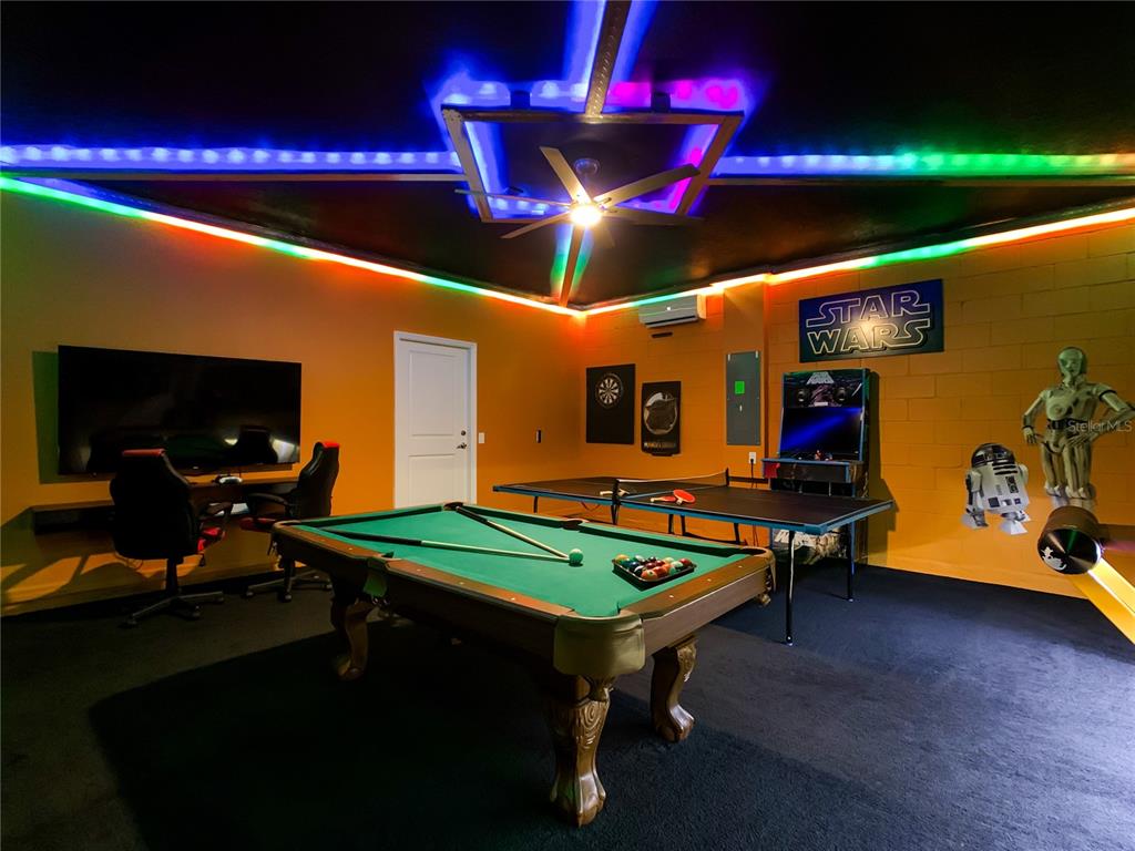 A game room features a pool table, ping pong table, Star Wars decor, and LED lighting — 3401 LILAC WAY, DAVENPORT, FL