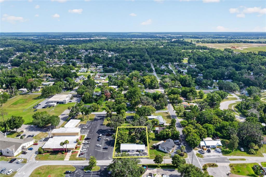 An aerial view shows a single-story house outlined in yellow within a suburban neighborhood — 5425 SE 111TH STREET, BELLEVIEW, FL