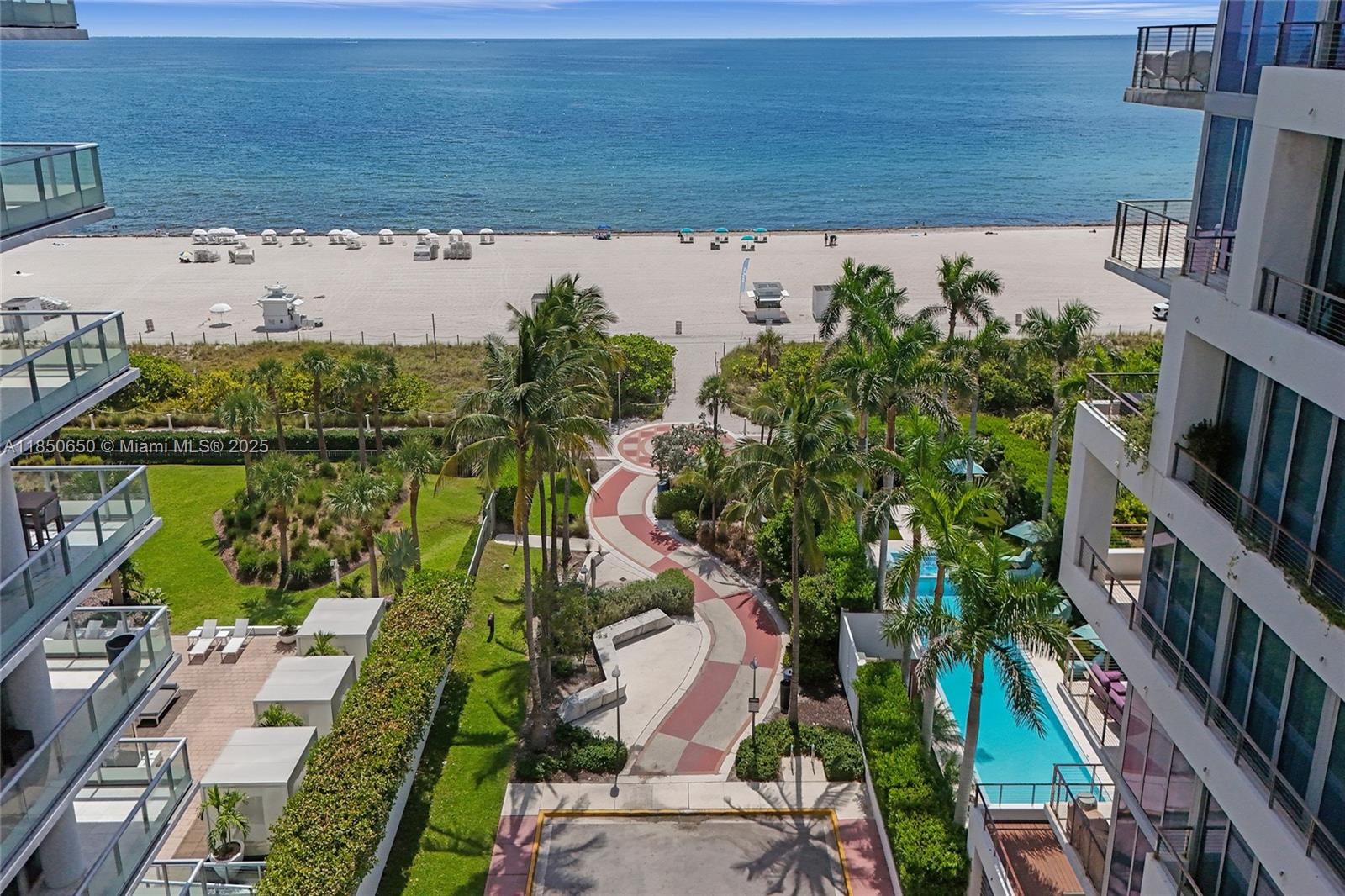 An elevated view shows a beach, a winding walkway, palm trees, and a swimming pool — 3710 Collins Ave # 100, Miami Beach FL 33140, MIAMI BEACH, FL