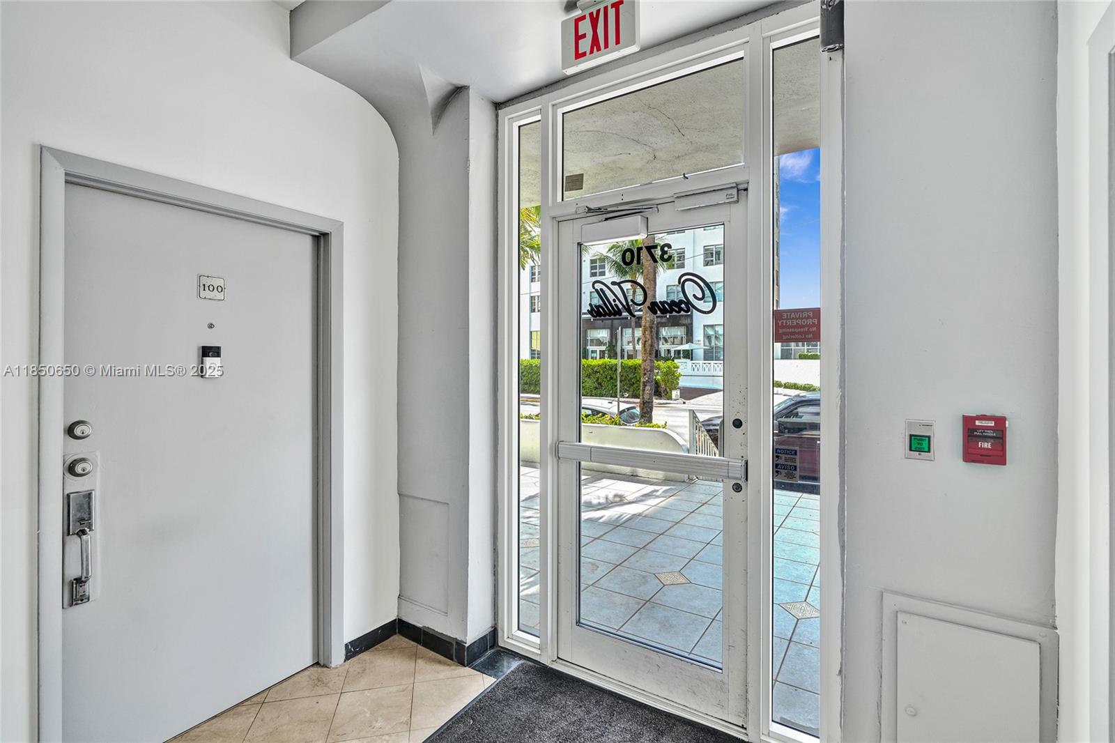 A white door labeled 100 stands next to a glass exit door leading outside — 3710 Collins Ave # 100, Miami Beach FL 33140, MIAMI BEACH, FL