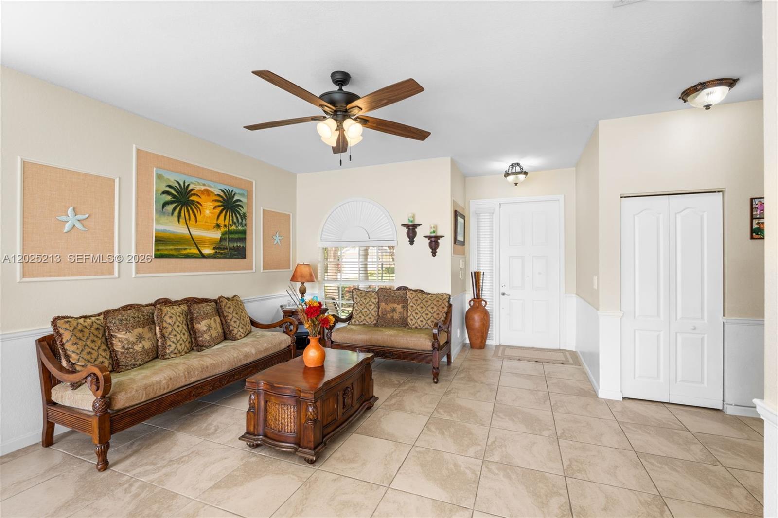 A living room features tile flooring, a ceiling fan, and traditional wooden furniture — 116 Berenger Walk, Royal Palm Beach FL 33414, ROYAL PALM BEACH, FL