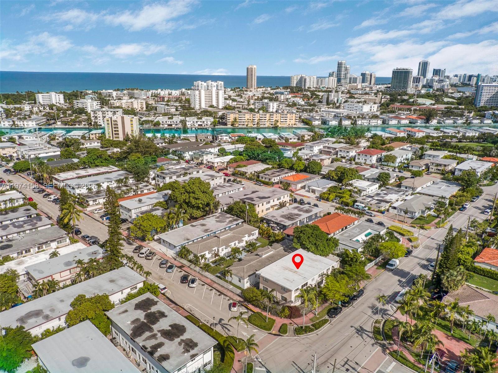 An aerial view shows a low-rise apartment building marked with a red pin in a neighborhood — 8031 Hawthorne Ave, Miami Beach FL 33141, MIAMI BEACH, FL