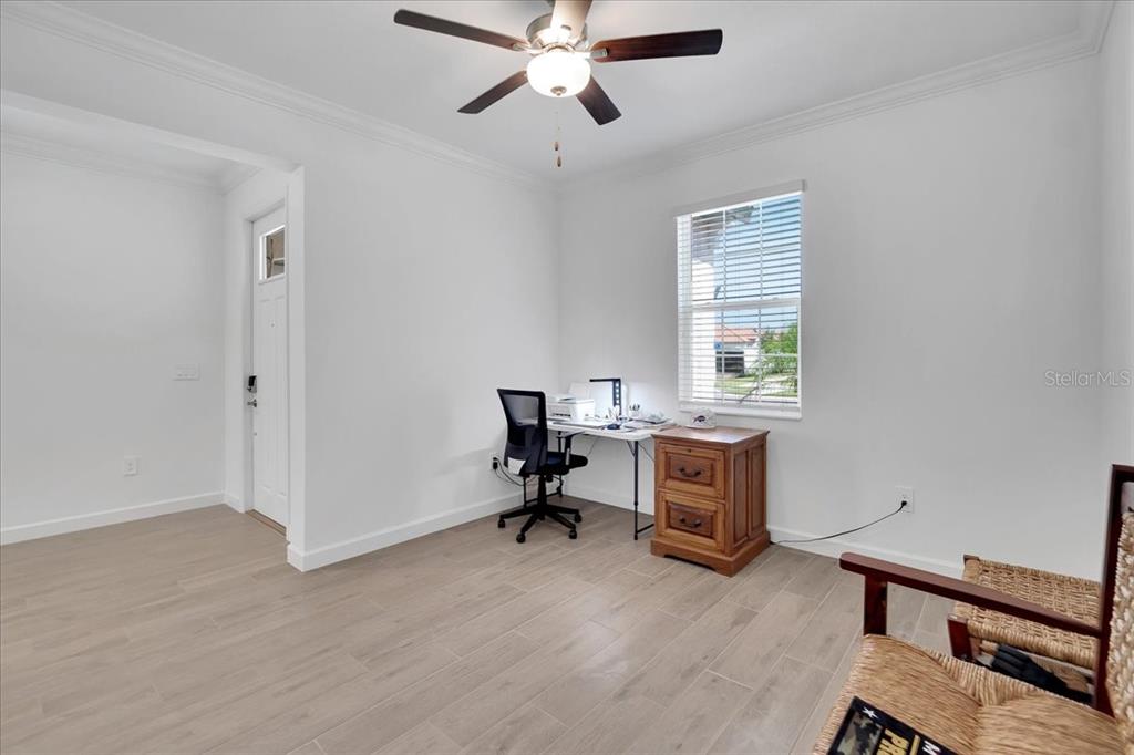 A room with light-colored tile flooring, a ceiling fan, a window, and a desk — 17410 HOLLY WELL AVENUE, WIMAUMA, FL