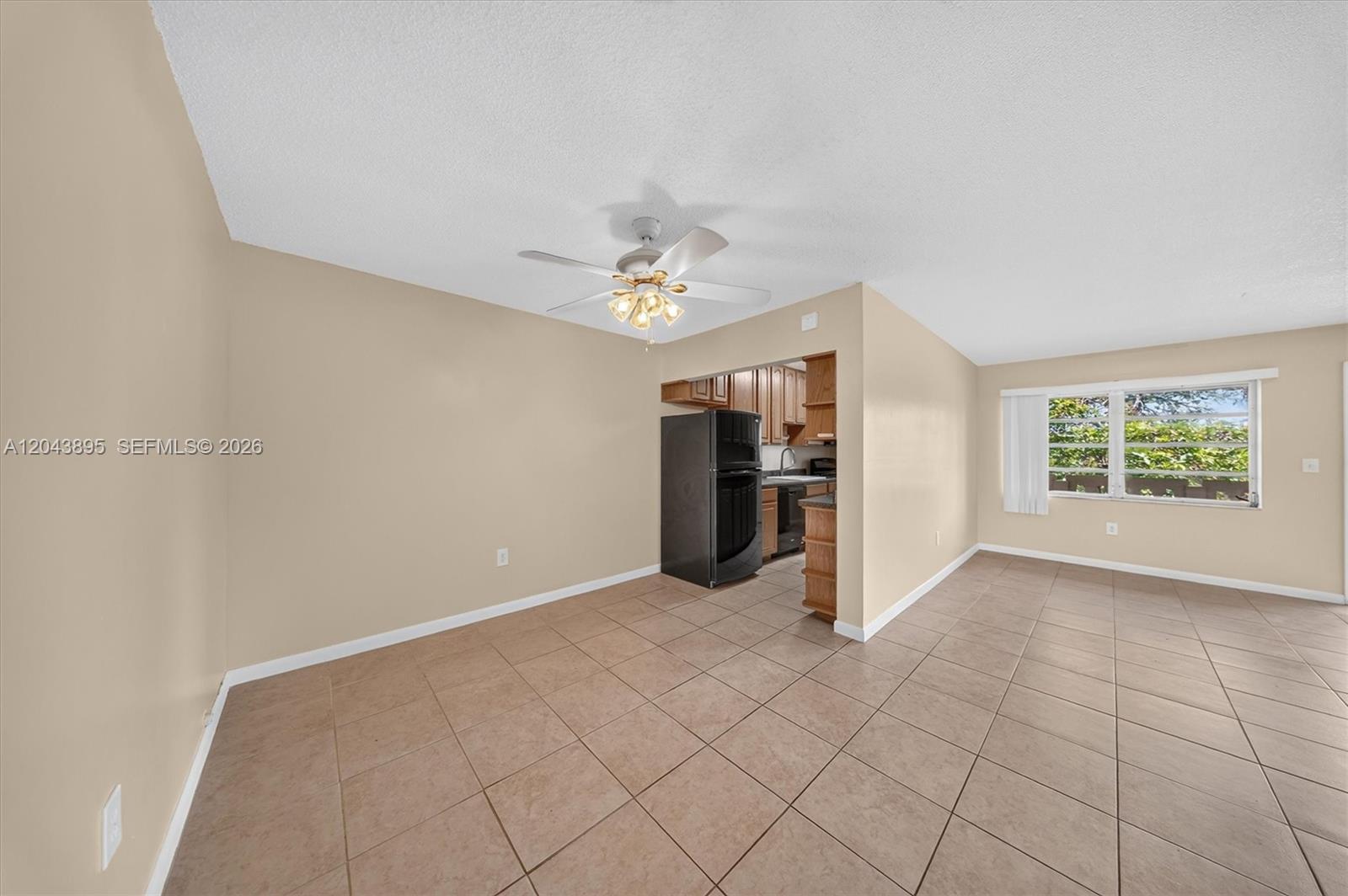 An open-concept dining area features beige walls, tile flooring, and a ceiling fan — 20311 NE 2nd Ave # 21, Miami FL 33179, MIAMI, FL