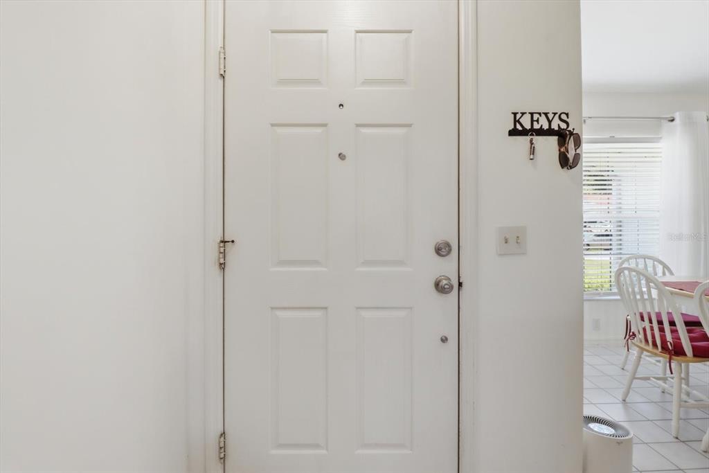 A white front door with a key hook rack on the adjacent wall — 685 W COLBERT COURT, BEVERLY HILLS, FL