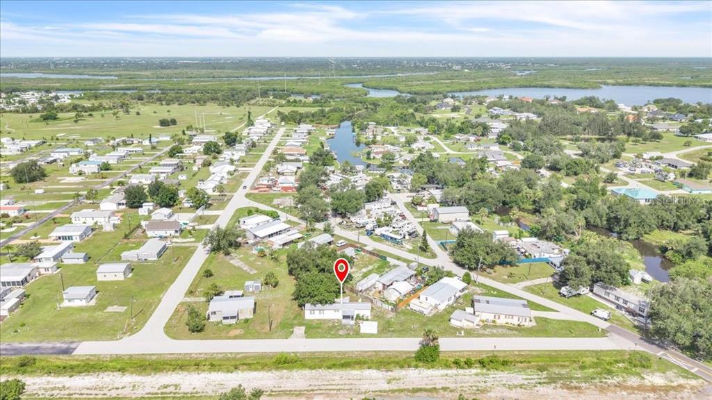 An aerial view shows a single-story house marked with a pin in a residential neighborhood — 1169 LAFAYETTE STREET, PUNTA GORDA, FL