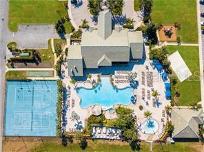 An aerial view shows a community clubhouse with a swimming pool, tennis courts, and playground — 8985 CUBAN PALM RD. ROAD, KISSIMMEE, FL