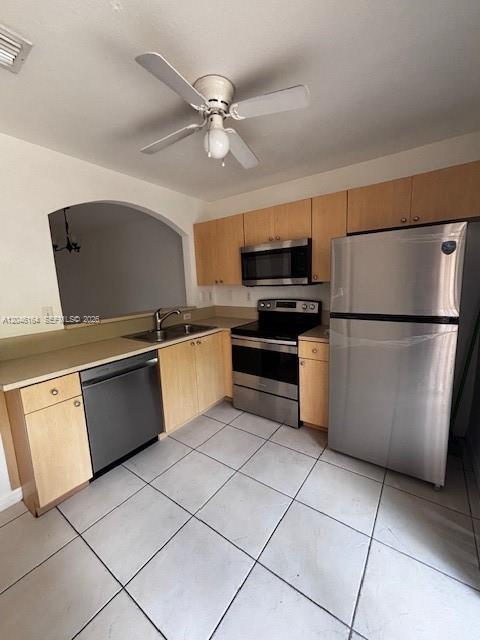 A kitchen features light wood cabinets, stainless steel appliances, and light-colored tile flooring — 13726 SW 171st Ln, Miami FL 33177, MIAMI, FL