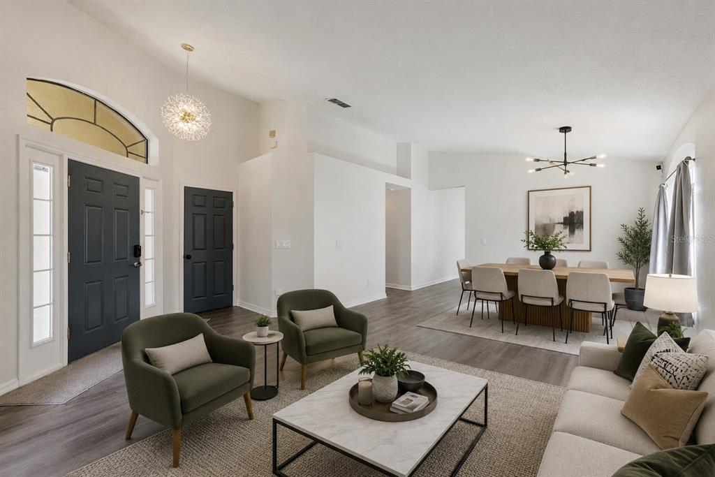 A living and dining area features dark wood floors, white walls, and modern light fixtures — 6629 WINDER OAKS BOULEVARD, ORLANDO, FL