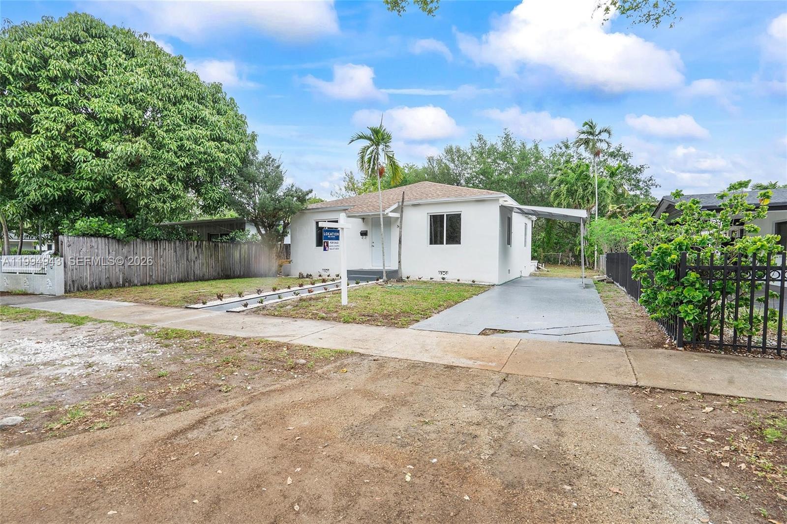 A white single-story house features a paved driveway, a carport, and a front lawn — 511 NE 131st St, North Miami FL 33161, NORTH MIAMI, FL