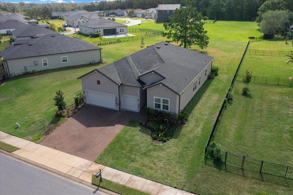 An aerial view shows a single-story house with a two-car garage and fenced yard — 1130 SE 42ND ROAD, OCALA, FL