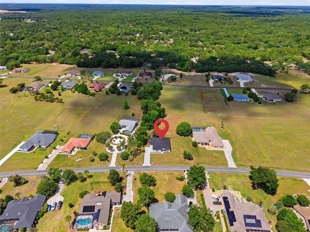 An aerial view shows a single-family home with a red location pin on a lot — 464 N CHERRY POP DRIVE, INVERNESS, FL