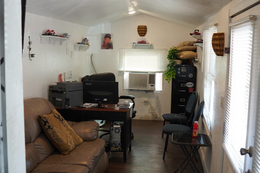 A small home office with a desk, computer, sofa, and window air conditioning unit — 2610 E DR MARTIN LUTHER KING JR BOULEVARD, TAMPA, FL