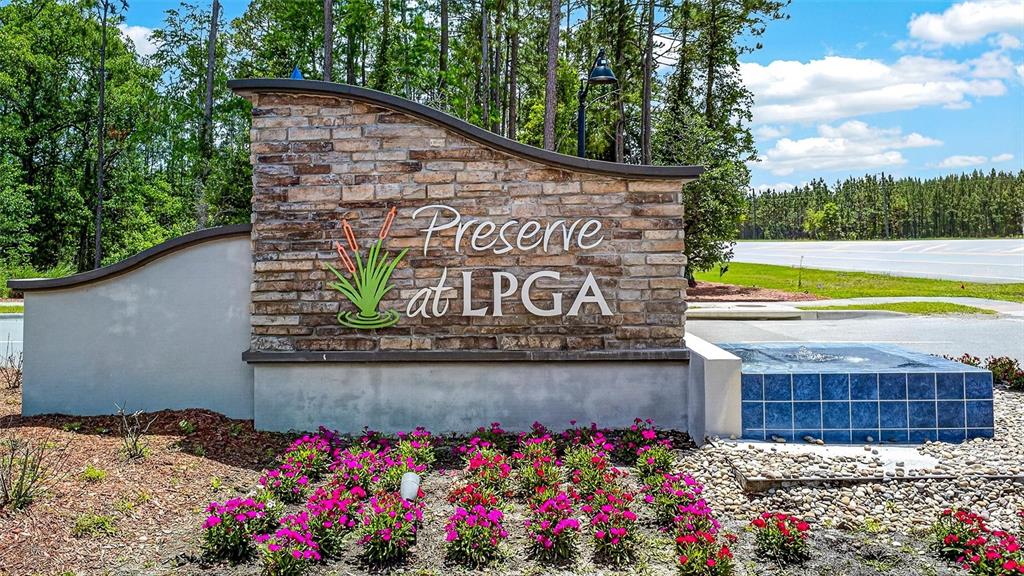 A stone monument sign for Preserve at LPGA sits in front of a landscaped garden — 223 WINGED FOOT LANE, DAYTONA BEACH, FL