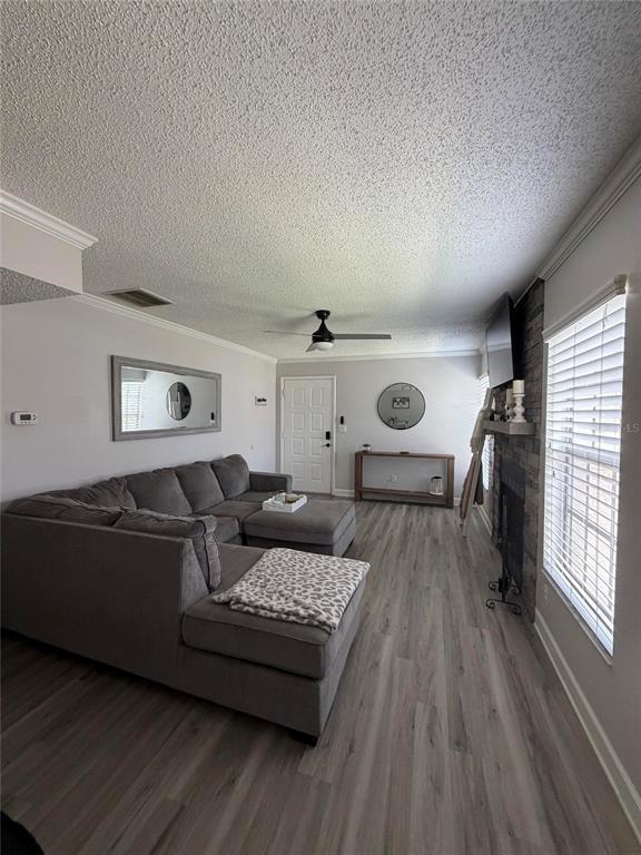 A kitchen sink and countertop overlook a dining area with a window and fireplace — 3024 BONAVENTURE CIRCLE UNIT 204, PALM HARBOR, FL