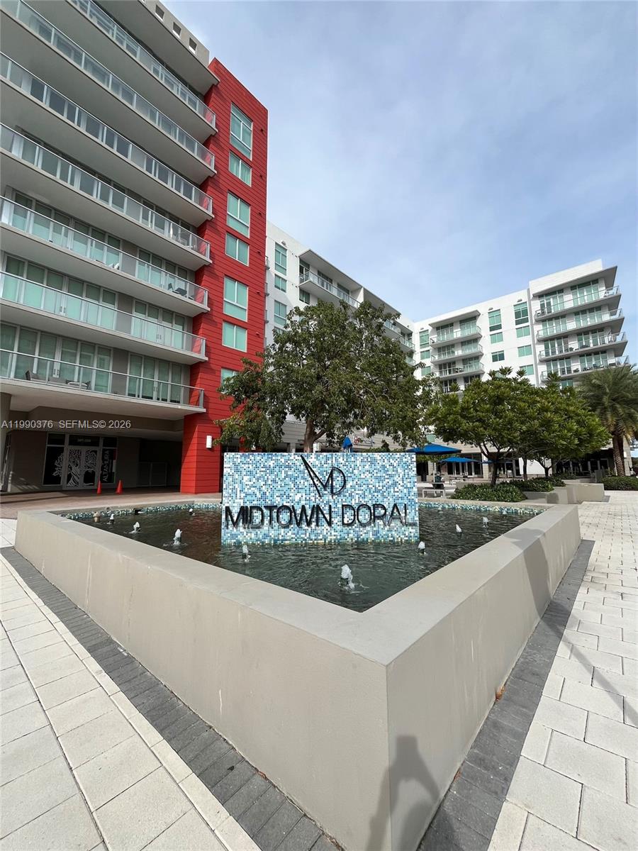 A fountain with a Midtown Doral sign sits in front of a modern apartment building — 7661 NW 107th Ave # 706, Doral FL 33178, DORAL, FL