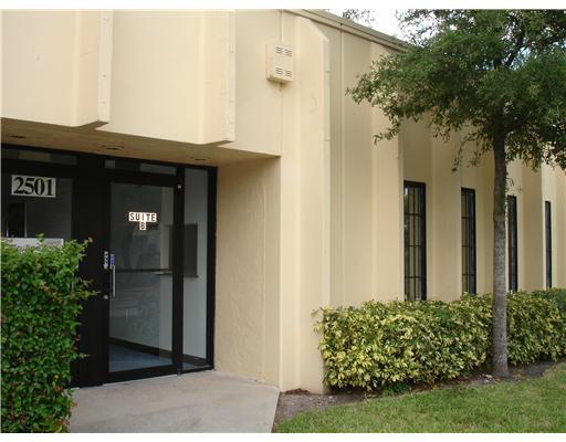 The exterior of a beige commercial building features a glass entrance door labeled Suite B — 2501 NW 17th Lane # B, Pompano Beach FL 33064, POMPANO BEACH, FL