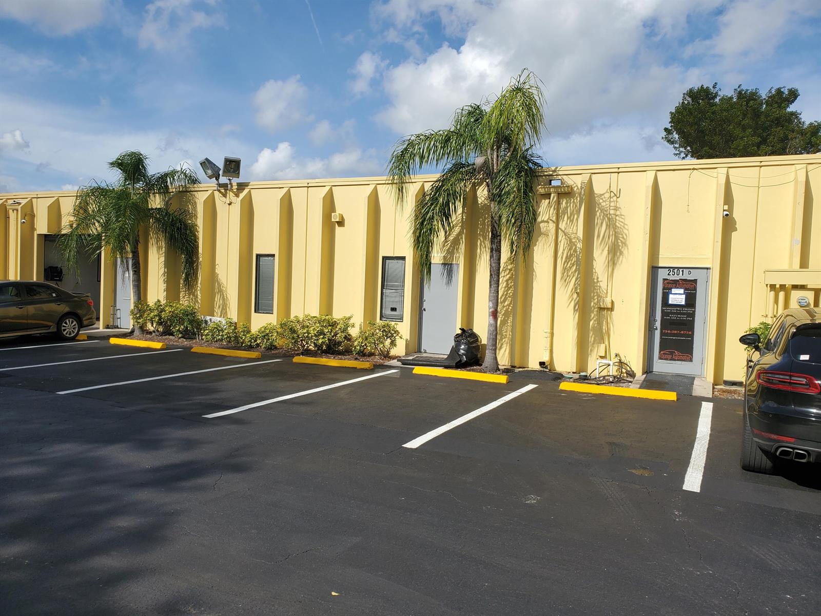 A yellow commercial building with palm trees and parking spaces in front — 2501 NW 17th Lane # B, Pompano Beach FL 33064, POMPANO BEACH, FL