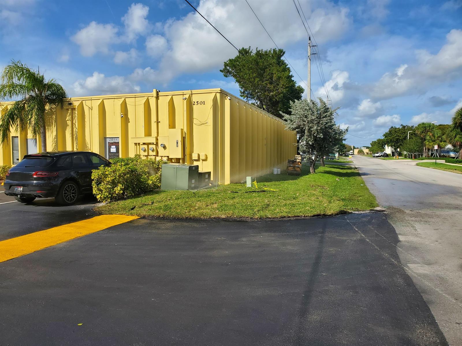 A yellow industrial building with a black SUV parked in front on a sunny day — 2501 NW 17th Lane # B, Pompano Beach FL 33064, POMPANO BEACH, FL