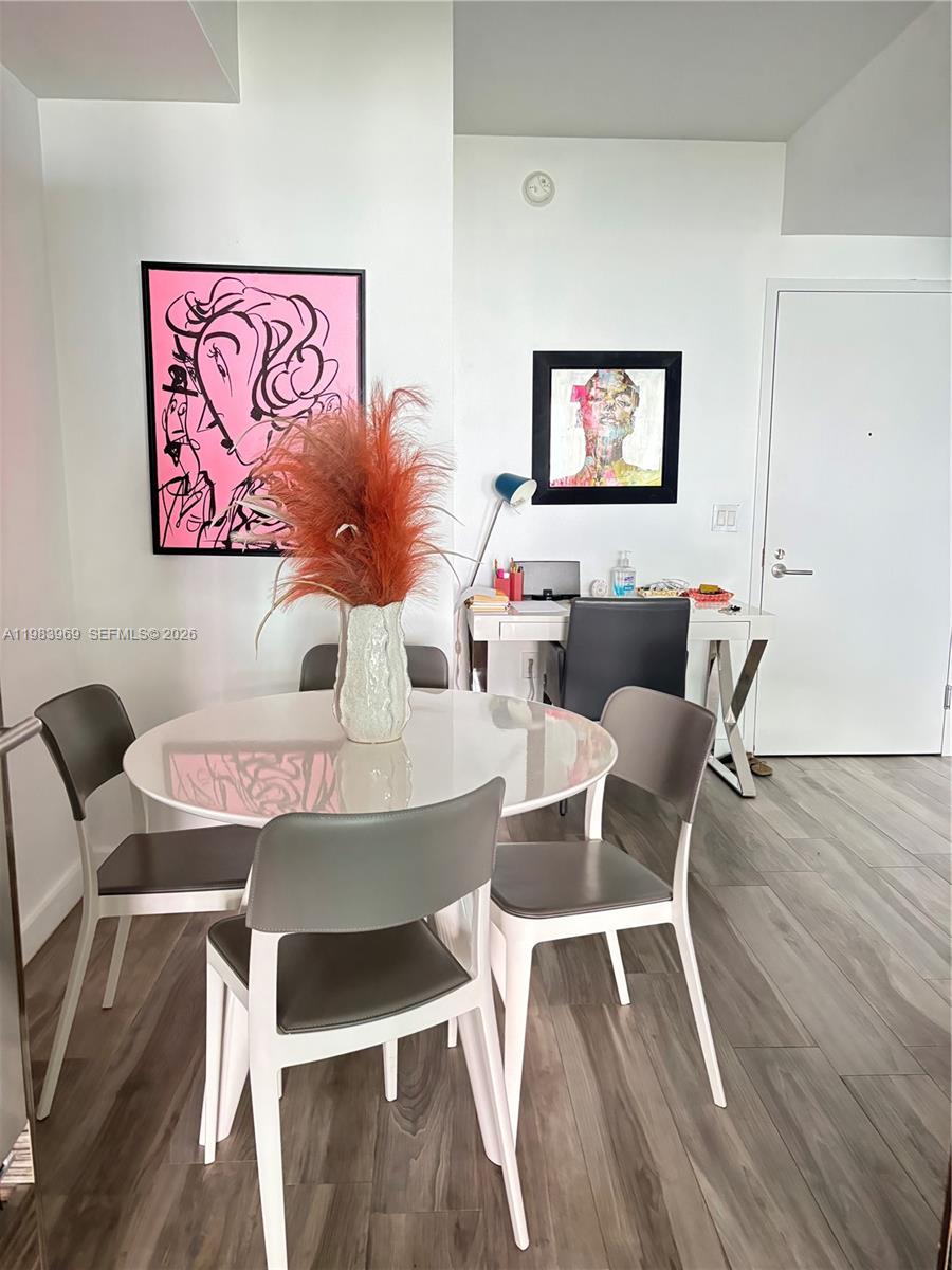 A dining area features a white round table, four chairs, and a small desk nearby — 460 NE 28th St # 2807, Miami FL 33137, MIAMI, FL