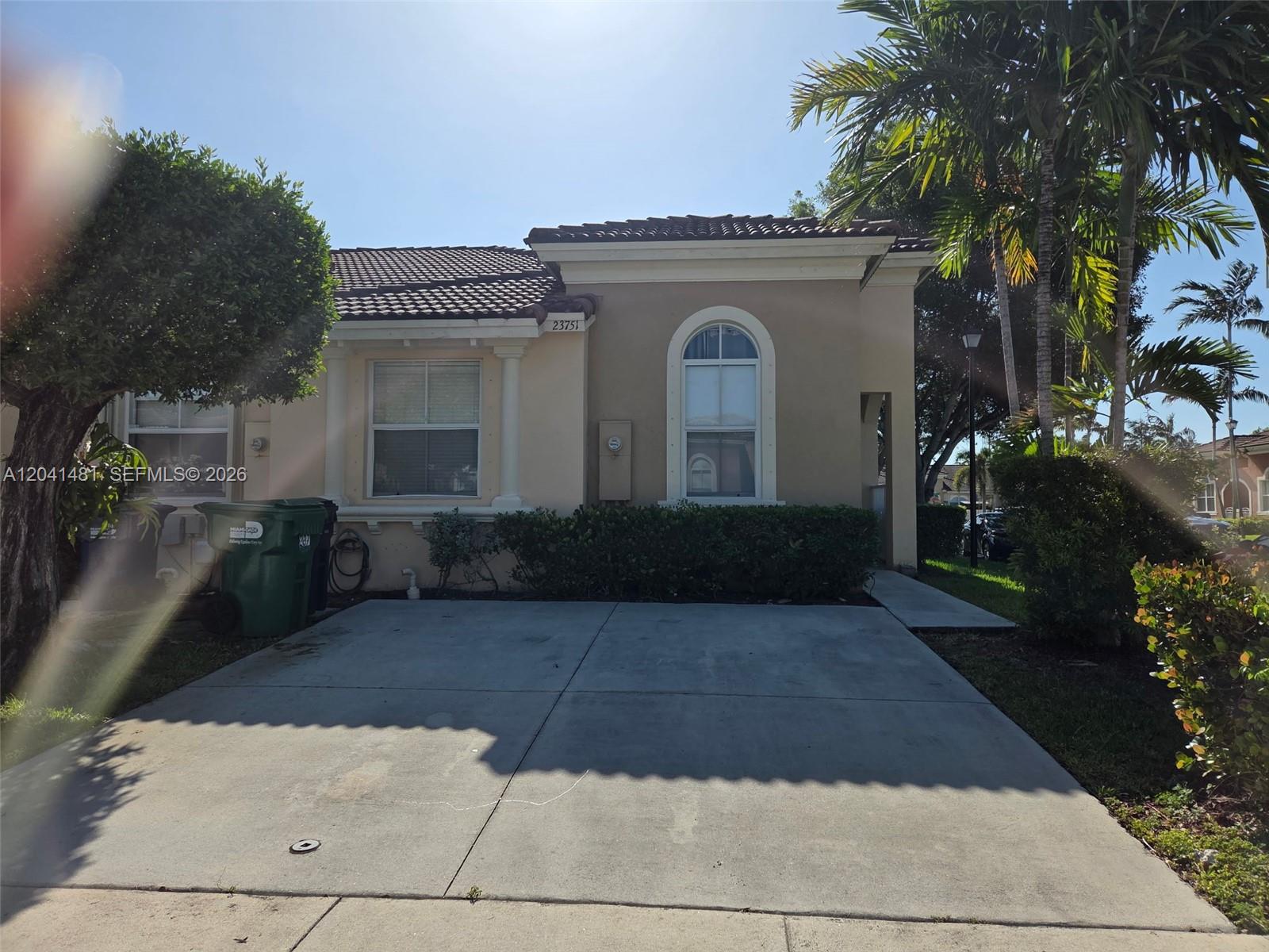 A single-story tan house with a concrete driveway and a tile roof — 23751 SW 110th Ave, Homestead FL 33032, HOMESTEAD, FL