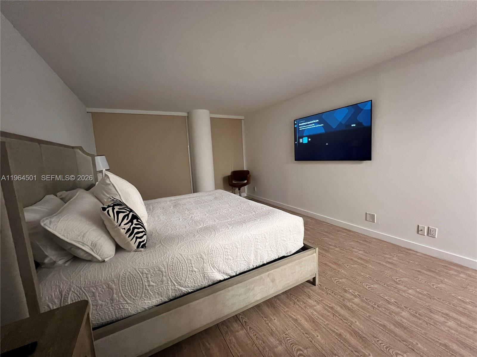 A hallway leads to a kitchen and a built-in bar area with white cabinets — 1717 N Bayshore Dr # 1057, Miami FL 33132, MIAMI, FL