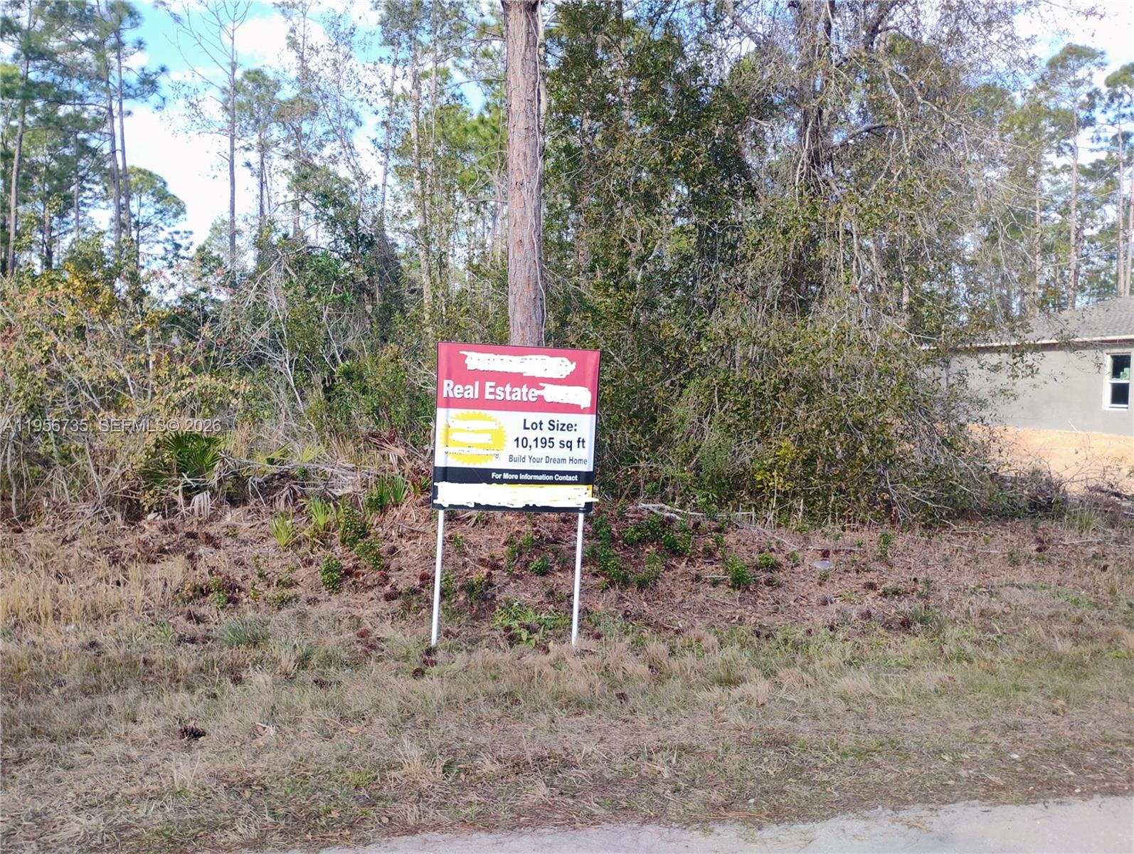 A real estate sign stands in front of a wooded, undeveloped residential lot — 4213 Gerona, Avon Park FL 33872, AVON PARK, FL