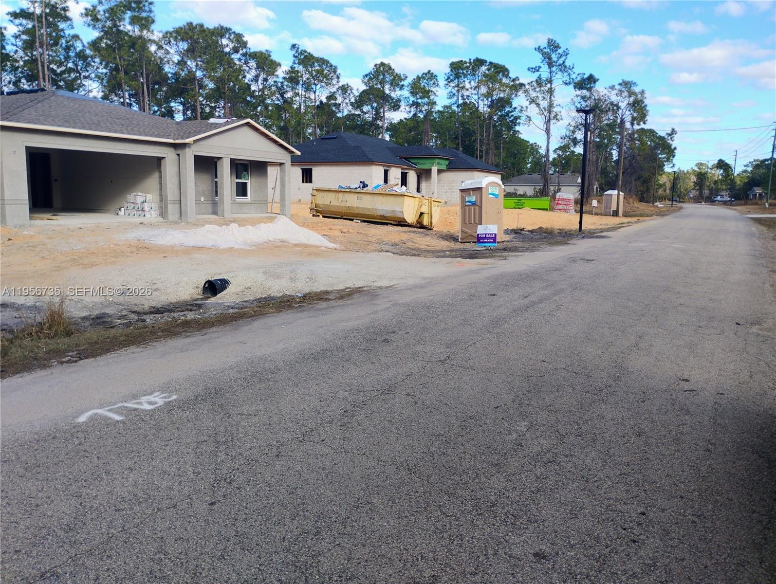 A street view shows two new houses under construction with a dumpster and portable toilet — 4213 Gerona, Avon Park FL 33872, AVON PARK, FL
