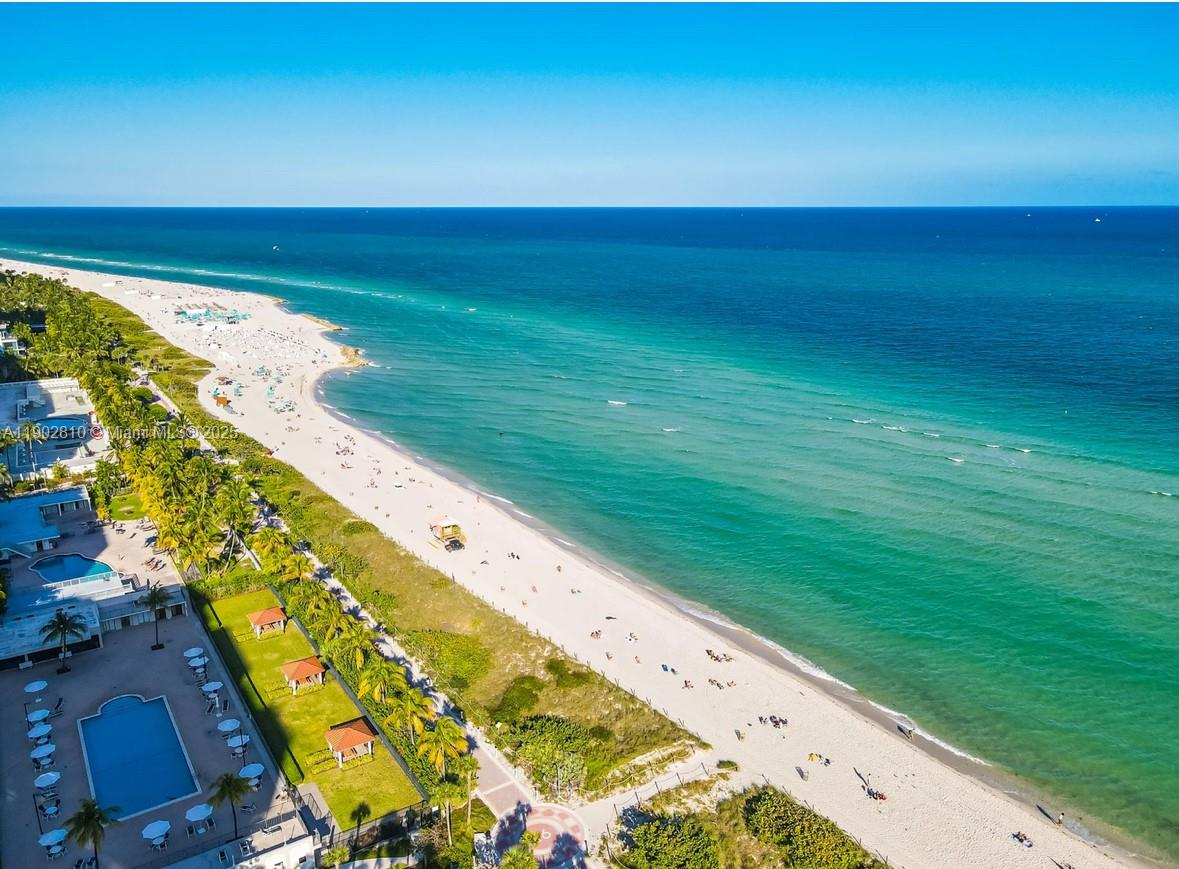 An aerial view of a sandy beach coastline with turquoise water and adjacent resort buildings — 2555 Collins Ave # 2200, Miami Beach FL 33140, MIAMI BEACH, FL