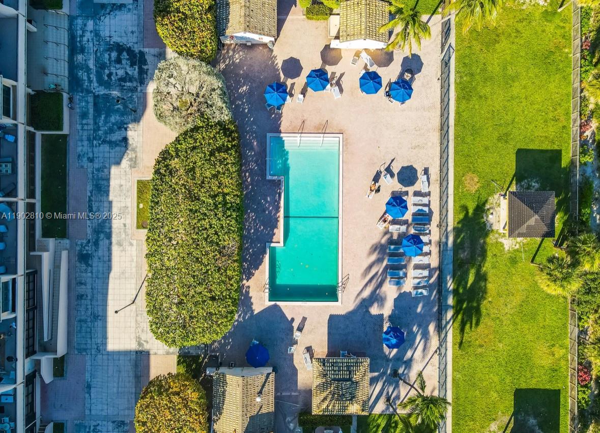 An aerial view shows a rectangular swimming pool surrounded by lounge chairs and umbrellas — 2555 Collins Ave # 2200, Miami Beach FL 33140, MIAMI BEACH, FL