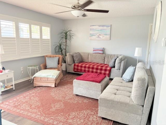 A living room features a beige sofa, a matching armchair, and a large patterned rug — 9427 SE 174TH PLACE ROAD, SUMMERFIELD, FL