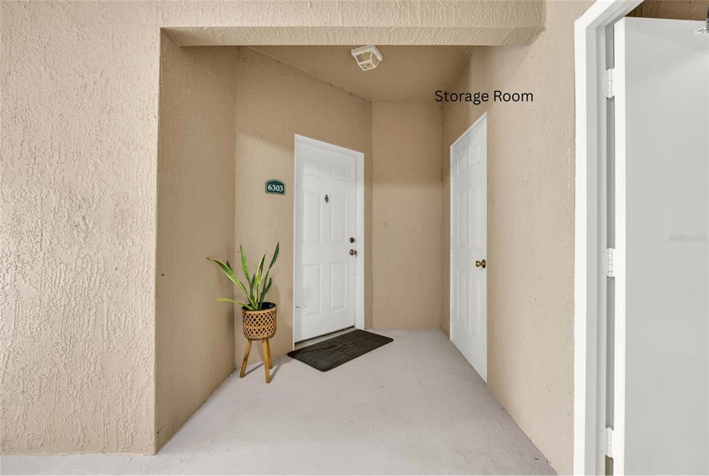 An exterior entryway features a white front door labeled 6303, a storage closet, and a plant — 4897 CYPRESS WOODS DRIVE UNIT 6303, ORLANDO, FL