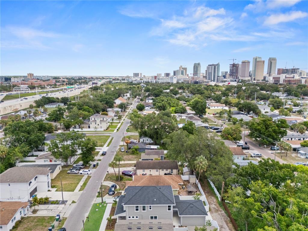 An aerial view shows a residential neighborhood with a city skyline in the background — 1522 W ARCH STREET, TAMPA, FL