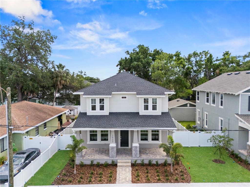 A two-story house with light siding, a dark roof, and a front porch — 1522 W ARCH STREET, TAMPA, FL