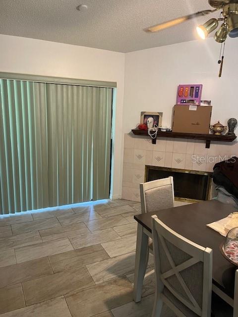 A dining area features tile flooring, vertical blinds, and a fireplace with a wooden mantel — 6280 MISSON DRIVE, ORLANDO, FL
