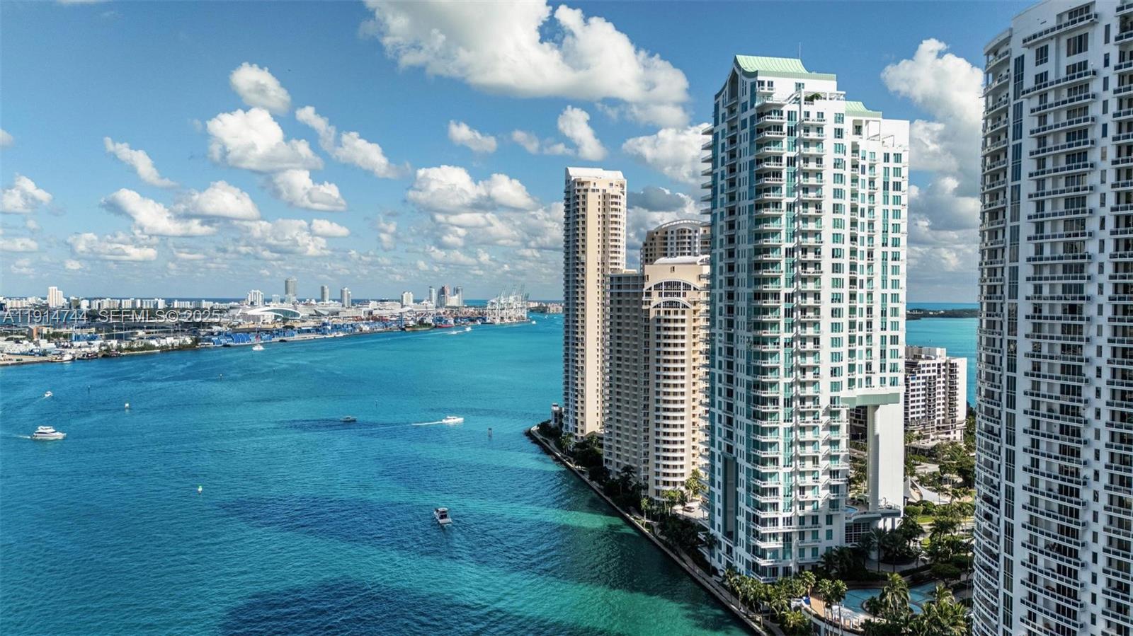 An aerial view of high-rise apartment buildings along a waterfront in Miami — 900 Brickell Key Blvd # 1403, Miami FL 33131, MIAMI, FL