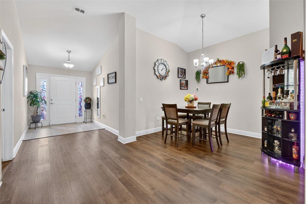 A kitchen features wood cabinets, granite countertops, stainless steel appliances, and a central island — 383 BUCHANNAN DRIVE, DAVENPORT, FL
