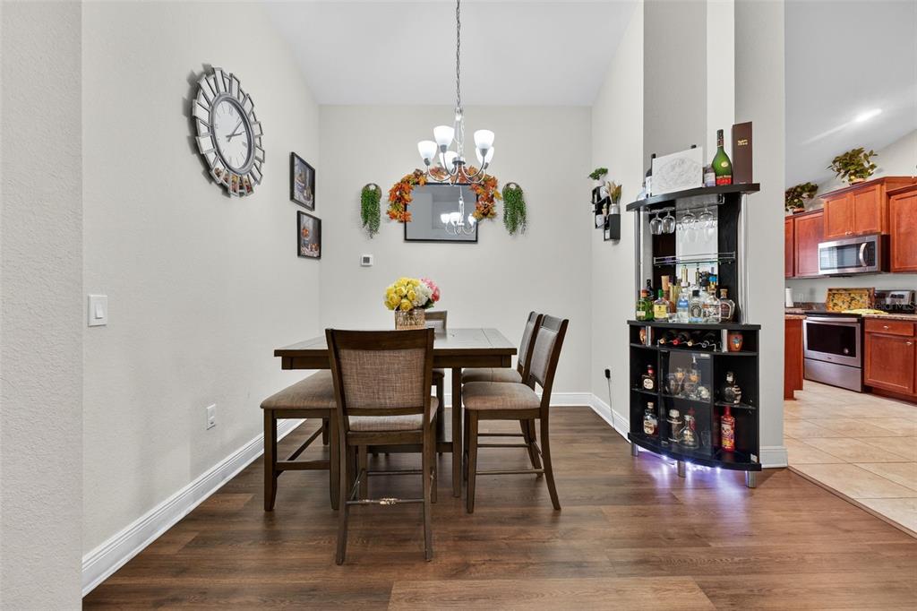 A dining area with a table and chairs sits next to a home entryway — 383 BUCHANNAN DRIVE, DAVENPORT, FL