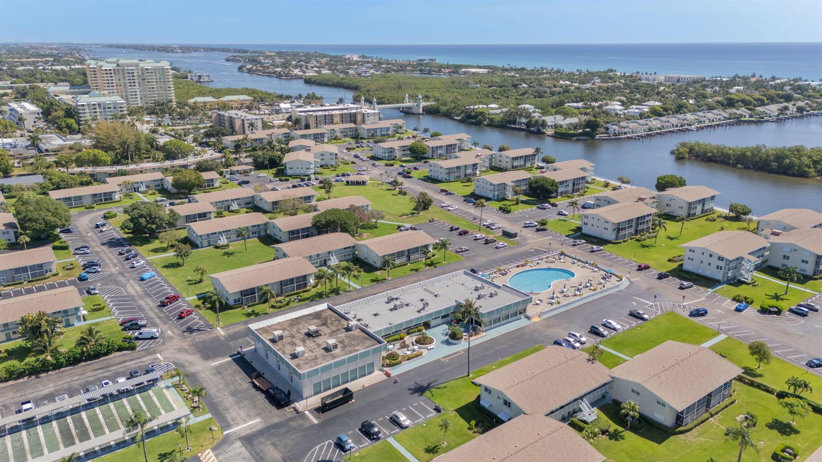 An aerial view shows a residential complex with multiple buildings, parking lots, and a pool — 740 W Horizons W # 203, Boynton Beach FL 33435, BOYNTON BEACH, FL
