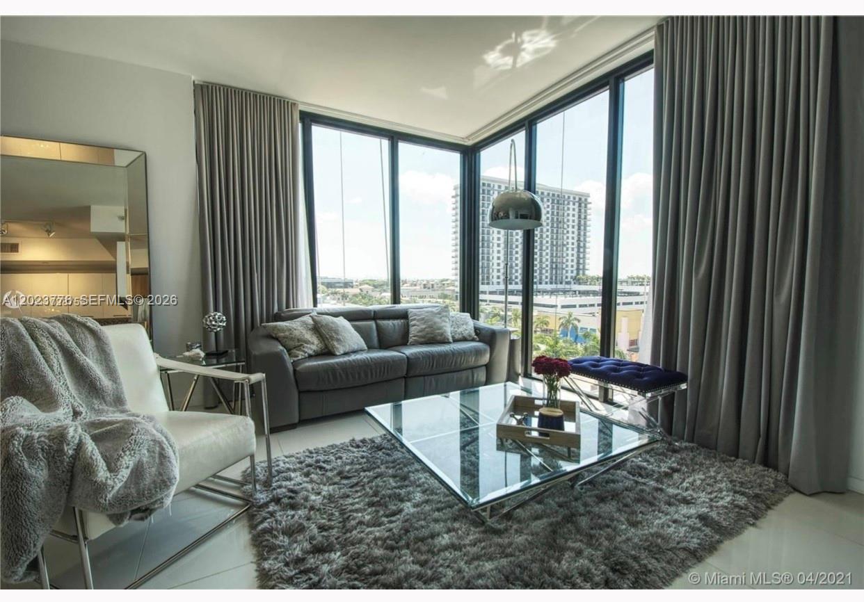 A modern living room features floor-to-ceiling windows, a gray sofa, and a glass coffee table — 5300 Paseo Blvd   Unit 401 # 401, Doral FL 33166, DORAL, FL