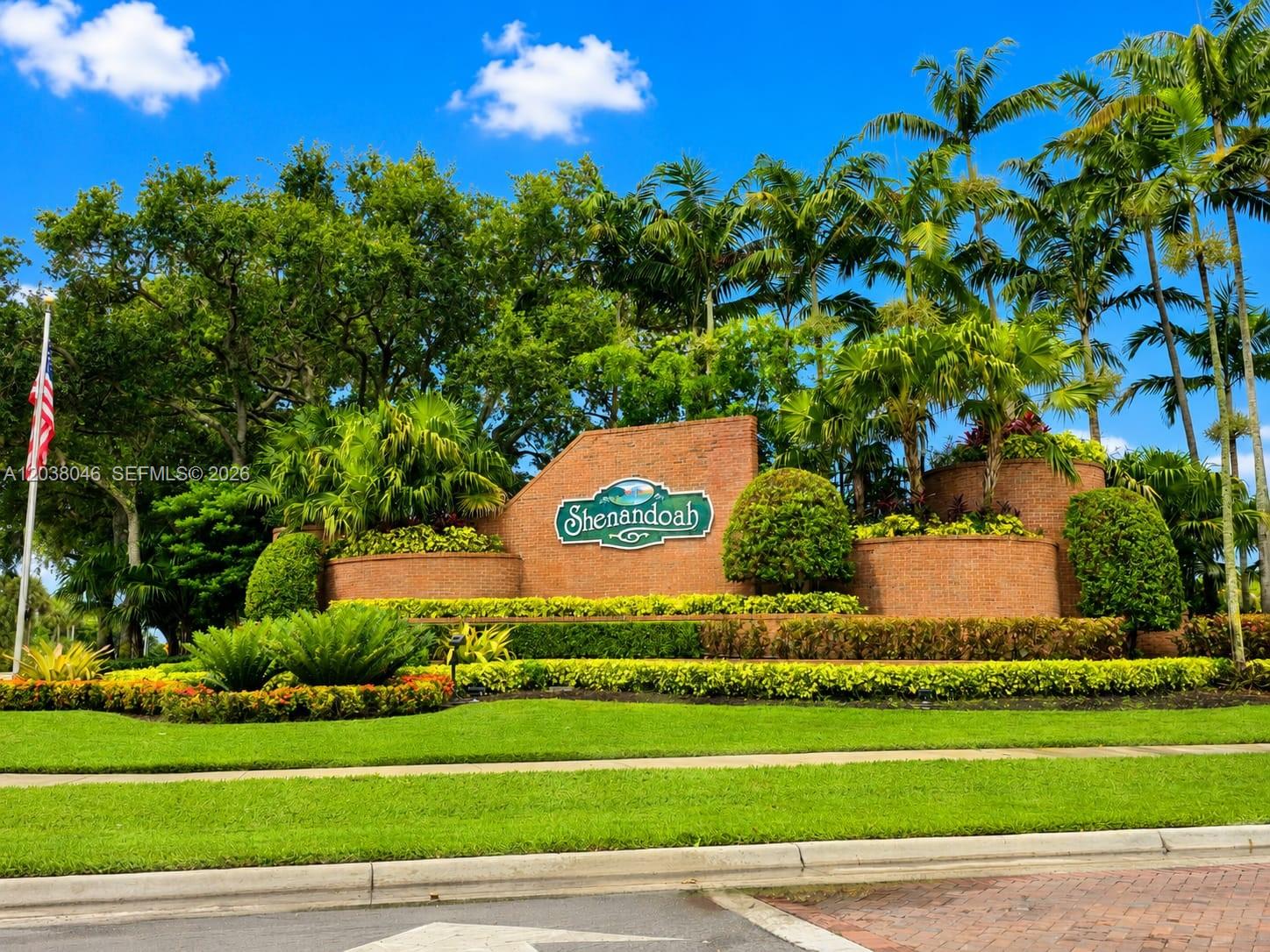 A brick entrance sign for Shenandoah stands surrounded by lush landscaping and palm trees — 13870 Magnolia Ct, Davie FL 33325, DAVIE, FL