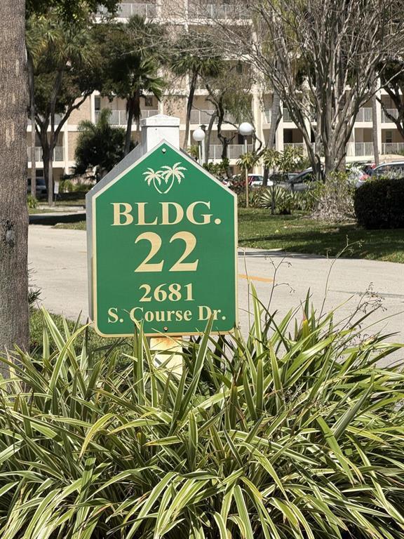 A green building identification sign stands in front of a multi-story residential complex — 2681 S Course Drive # 511, Pompano Beach FL 33069, POMPANO BEACH, FL
