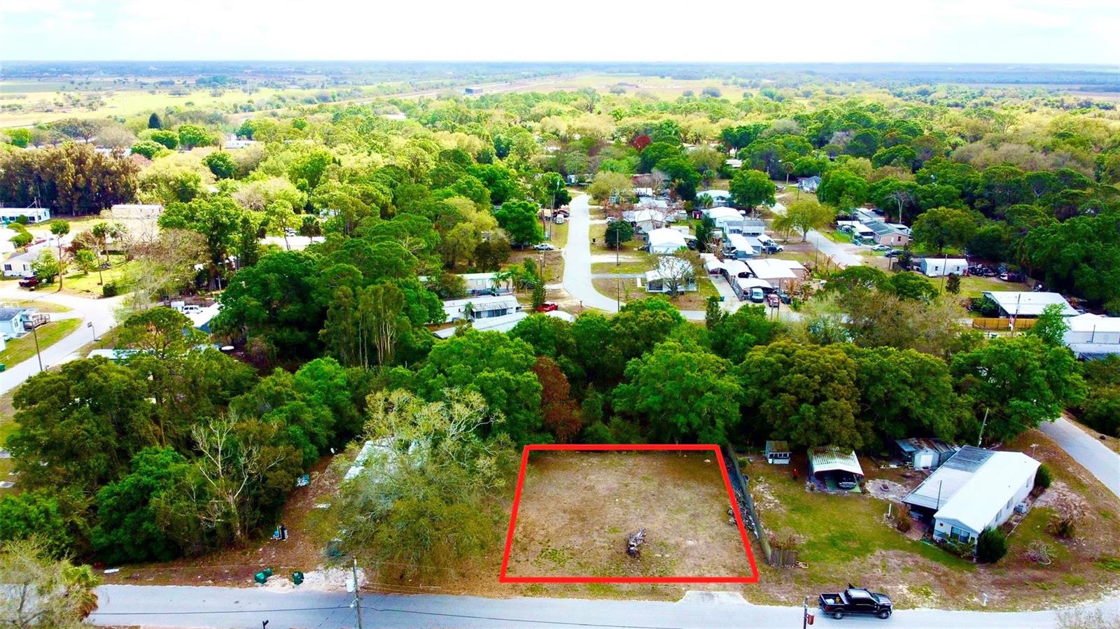 An aerial view shows a rectangular, cleared vacant lot bordered by trees and residential streets — 6040 SE 91st Trail, Okeechobee FL 34974, OKEECHOBEE, FL