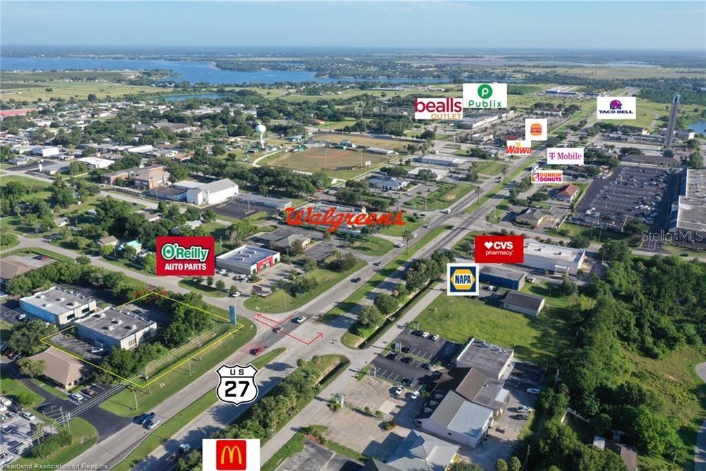 This aerial view shows a commercial area along US Highway 27 with various retail businesses — 346 E ROYAL PALM STREET, LAKE PLACID, FL