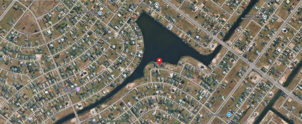 This is an aerial map view of a residential neighborhood surrounding a large lake — 520 NW 25TH TERRACE, CAPE CORAL, FL