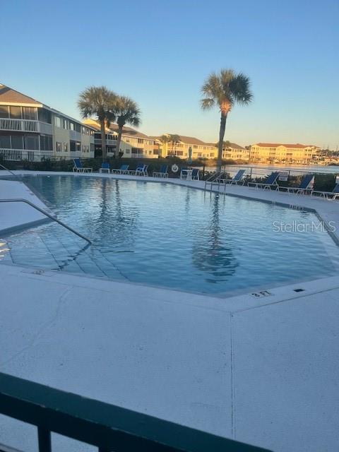 A swimming pool sits in front of multi-story residential buildings near a body of water — 901 OCEAN MARINA DRIVE UNIT 901, FLAGLER BEACH, FL