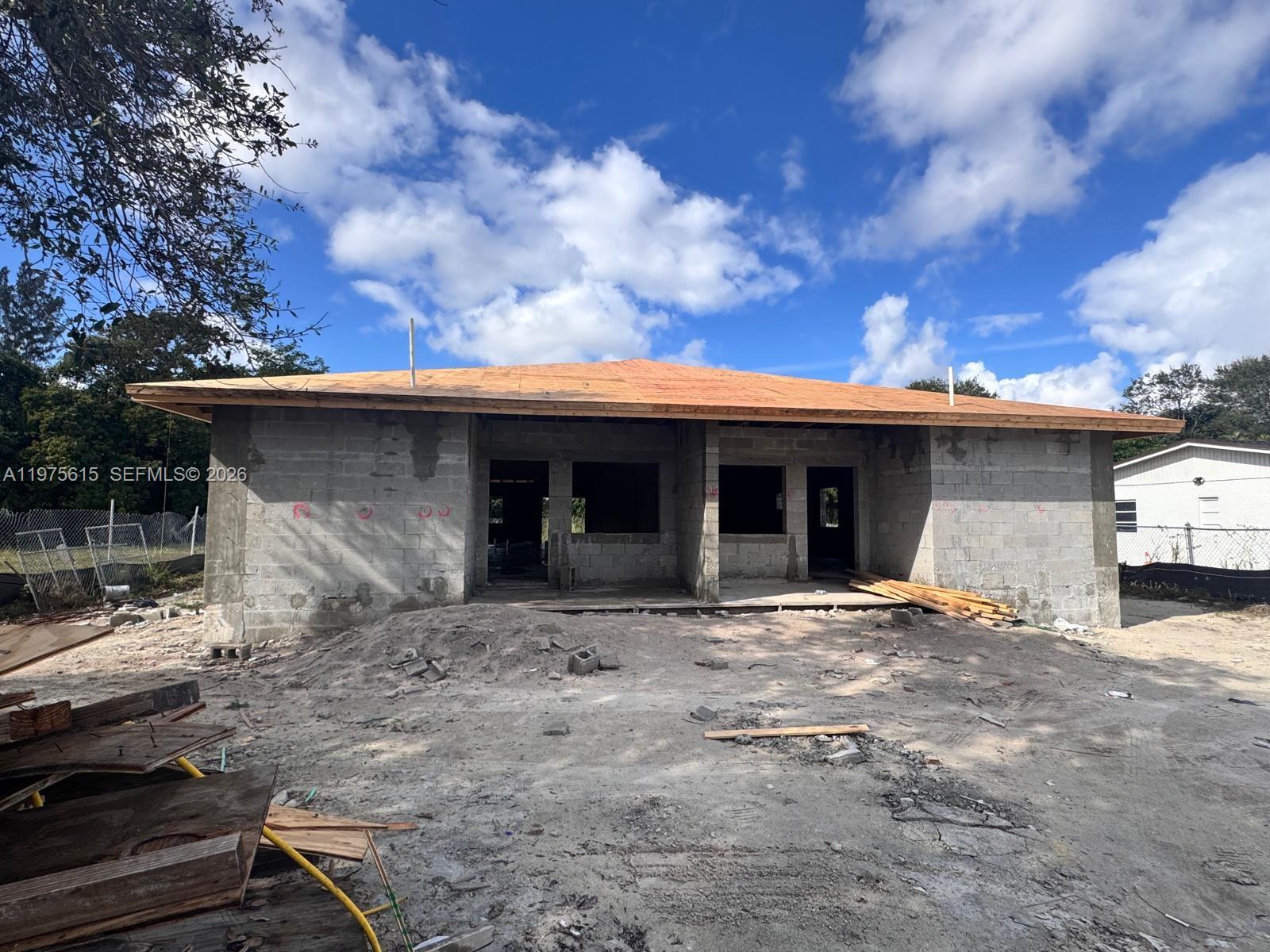 A single-story concrete block house under construction with a plywood roof deck — 15730 NW 38th Pl, Miami Gardens FL 33054, MIAMI GARDENS, FL